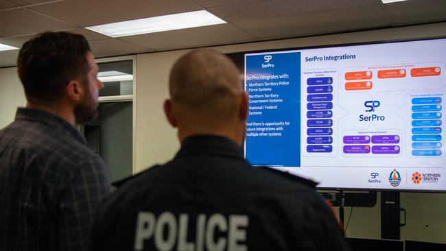 Minister Brent Potter and Acting Commander John Atkin looks at the SerPro integrated digital policing system in the NT. Picture: Pema Tamang Pakhrin