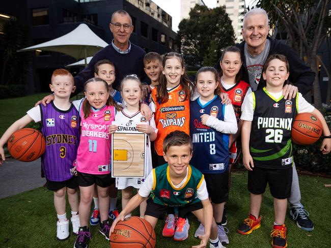 MELBOURNE, AUGUST 8, 2023: Aussie basketball great Andrew Gaze and his on-air partner Andy Maher are getting behind the SuperCoach NBL Search for the Super Coach competition which will see one grassroots basketball club win up to $10,000. Maher and Gaze are pictured with junior players from the Yarrambat Phantoms Basketball Club. Picture: Mark Stewart