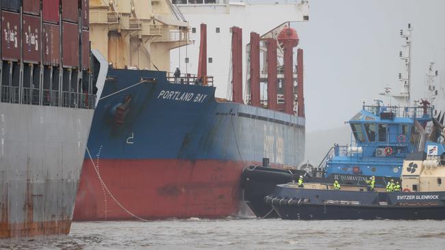 People can be seen on deck of the bulk carrier Portland Bay at bert in Port Botany on Wednesday. Picture: Damian Shaw