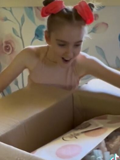 Monroe’s look of disbelief and joy as she opens the mystery box sent by Dollcake.