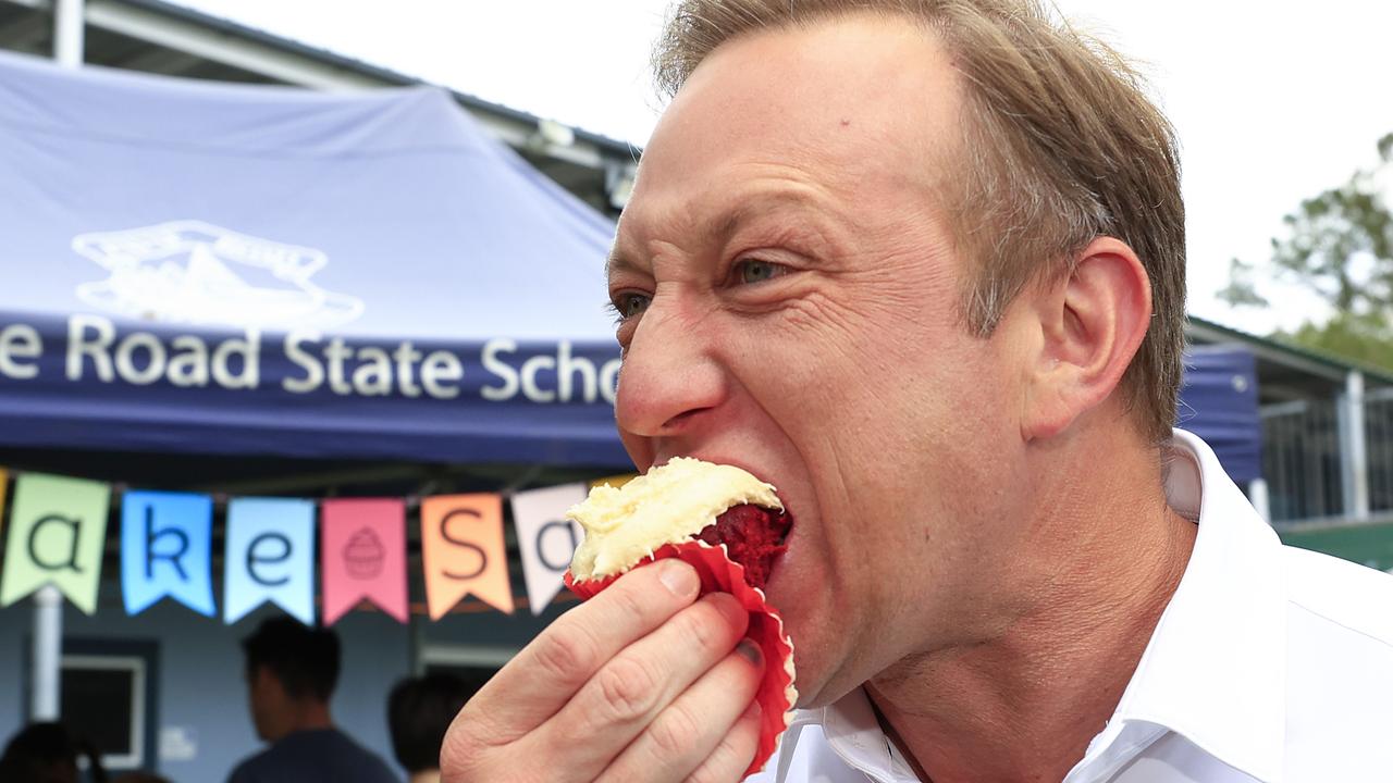 Premier Steven Miles tests some wares from the cake stall at Payne Road State School. Pics Adam Head