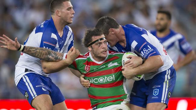 South Sydney backrower Ethan Lowe is tackled by a swarm of Bulldogs. Picture: AAP