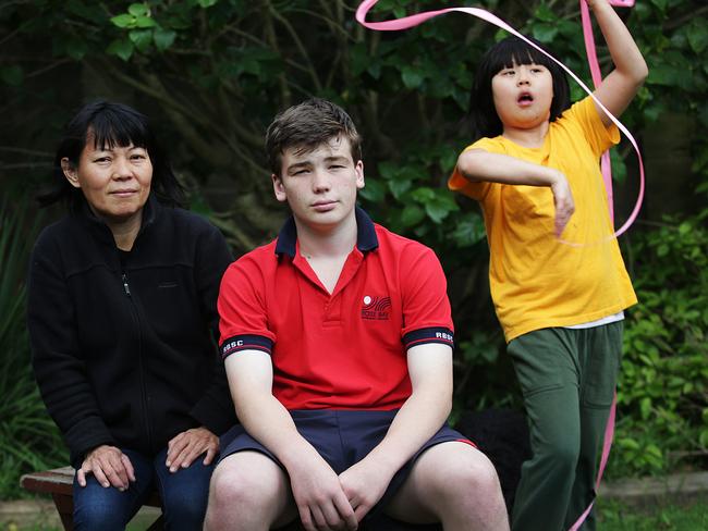 Mei Tieng Lim and her autistic daughter Emeline Yuwono with supporter, Damien Hill.