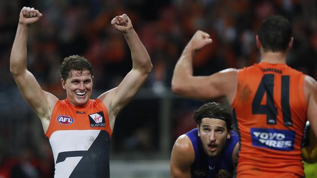 Giants Jacob Hopper and Shane Mumford celebrate their win.