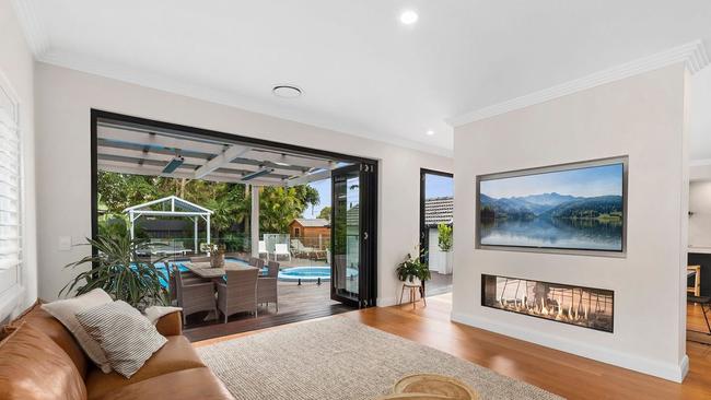 A two-way fireplace separates the living and dining areas in Hynes’ new Caringbah home.