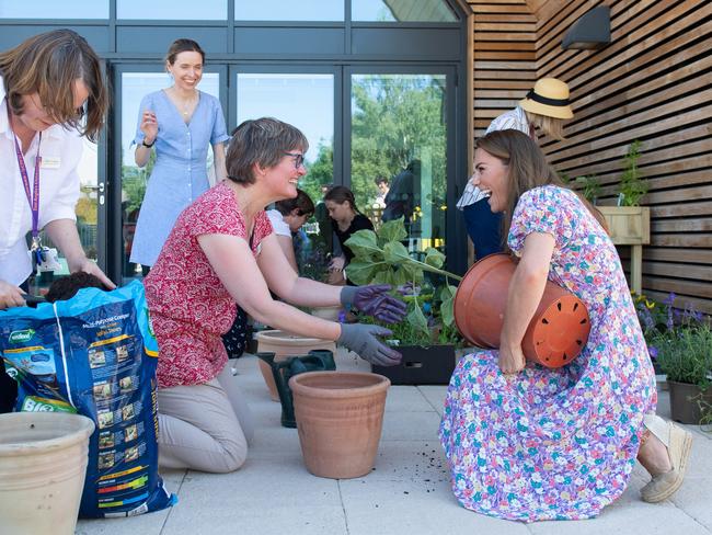 Catherine, Duchess of Cambridge helps to pot plants and herbs. Picture: Getty