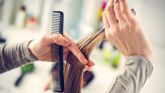 Close-up of a hairdresser cutting the hair of a woman. Picture: Milan Markovic