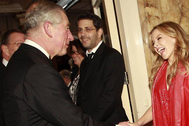 Britain's Prince Charles shakes hands with Minogue as he arrives to attend the Royal Variety Performance at the London Palladium, in London in December 2010. Shortly before, the car carrying the Prince and his wife the Duchess of Cornwall, had been attacked by rampaging students protesting against increased university fees. Picture: AP Photo/Eddie Keogh-pa