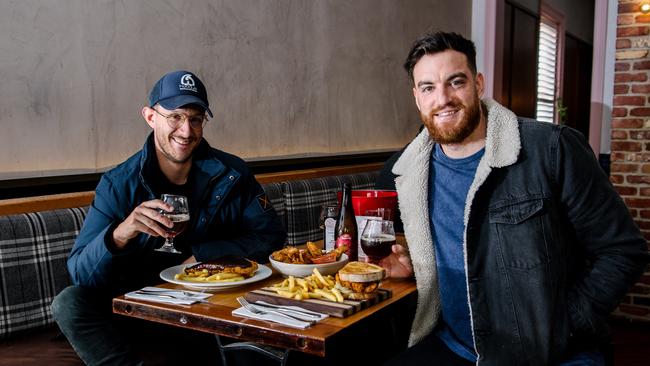 Nick Favaro and Kyle Nash enjoy a much-missed pub meal at the Gilbert Hotel in Adelaide. Picture: Morgan Sette