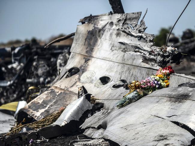 Flowers left by parents of an Australian victim of the crash were laid on a piece of the Malaysia Airlines plane MH17 in 2017. Picture: AFP