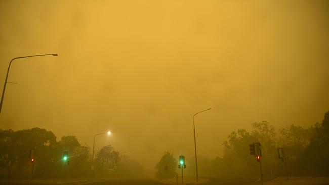 Empty streets are seen as smoke haze impacts suburbs early morning in Canberra. (AAP Image/Lukas Coch)