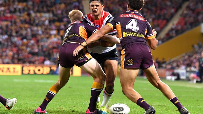 Latrell Mitchell drops the ball in a Broncos tackle. Picture: Bradley Kanaris/Getty Images