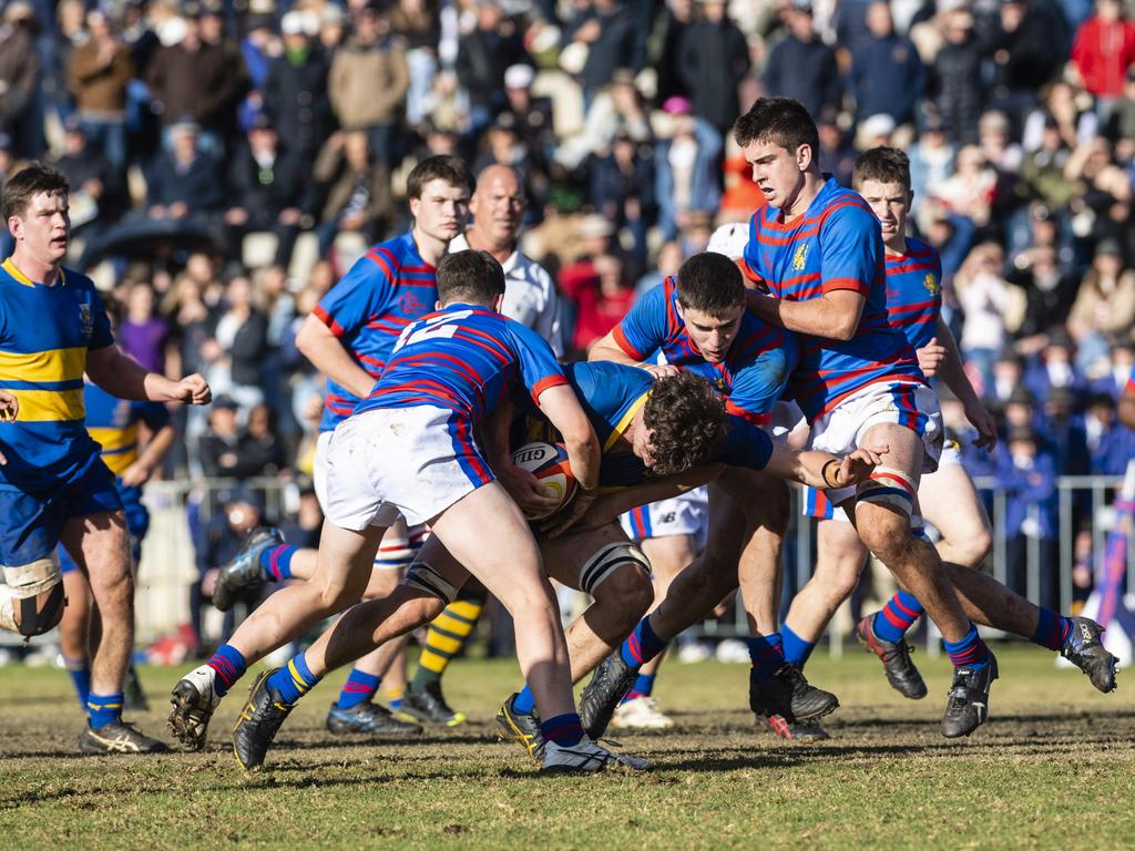 Downlands players (from left) Heath Lindenmayer, Jake Stephens and Rhys Chadburn attempt to stop Xander Jacobs of Grammar in O'Callaghan Cup on Grammar Downlands Day at Downlands College, Saturday, August 6, 2022. Picture: Kevin Farmer