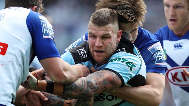 Cronulla's Josh Dugan is tackled during the Cronulla Sharks v Bulldogs NRL match at ANZ Stadium, Homebush. Picture: Brett Costello