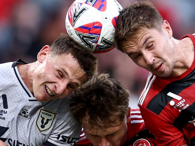 SYDNEY, AUSTRALIA - JANUARY 01: James Temelkovski and Alexander Bonetig of the Wanderers compete with Oliver Jones of the Bulls during the round 11 A-League Men match between Western Sydney Wanderers and Macarthur FC at CommBank Stadium, on January 01, 2025, in Sydney, Australia. (Photo by Brendon Thorne/Getty Images)