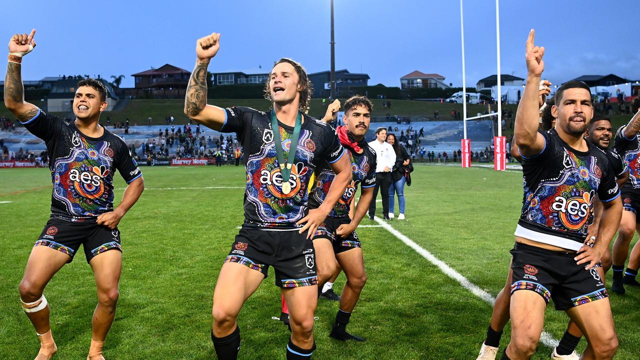 Latrell Mitchell, Nicho Hynes and Cody Walker of the Indigenous All Stars celebrate their victory.