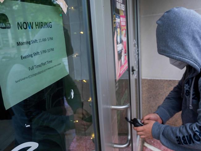 An employee gets keys to open a restaurant which is hiring in Arlington, Virginia. Picture: AFP