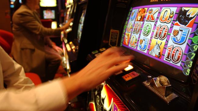 12/08/2003. Unidentified person plays poker machine. Generic images of Tabcorp, TAB. gambling pokies gaming machine.