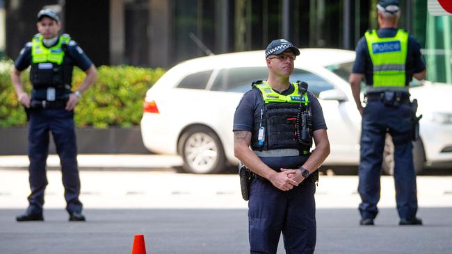 Police stand guard at Crown Promenade, where dozens of international travellers are staying during their mandatory quarantine period. Picture: Mark Stewart