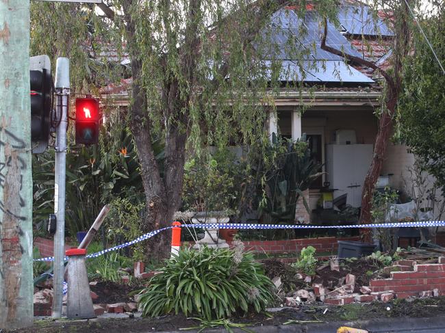 MELBOURNE, AUSTRALIA - NewsWire Photos - 03 JULY, 2024: A driver has been killed in a collision with a stolen car in Burwood. Damage to the front fence of a house that one of the cars crashed through. Wednesday, July 3, 2024. Picture: NewsWire / David Crosling