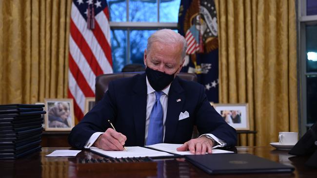 US President Joe Biden signs a series of orders at the White House after being sworn in. Picture: AFP