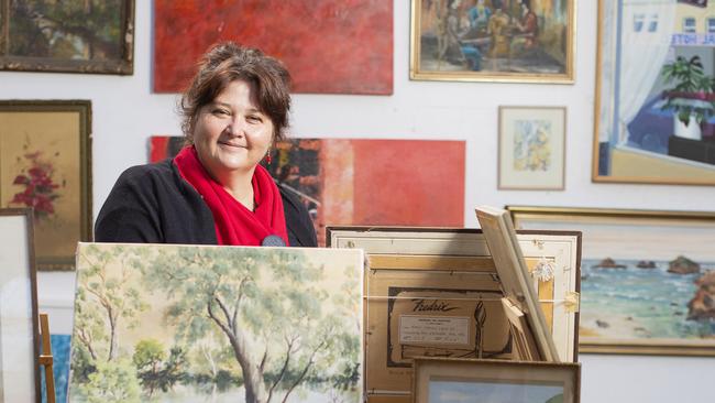 Kylie Eastley works at the South Hobart Resource Shop sorting out art treasures from the mix and re-homes them where they are more appropriate. Picture: RICHARD JUPE