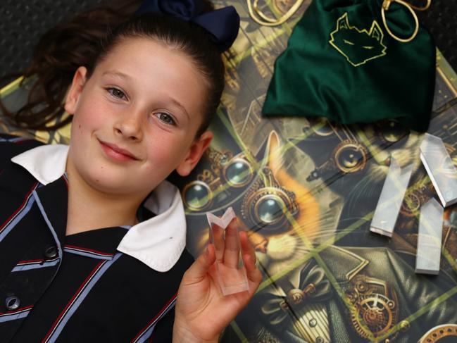 Mia Takos, 8, created a board game two years ago, making her the world's youngest board game inventor. Picture: Alison Wynd