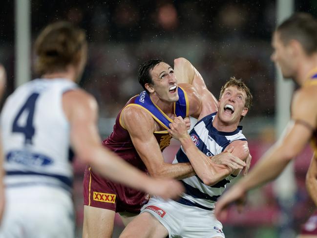 Oscar McInerney and Toby Conway contest one of the 119 stoppages at the Gabba on Saturday night. Picture: Russell Freeman/AFL Photos via Getty Images.