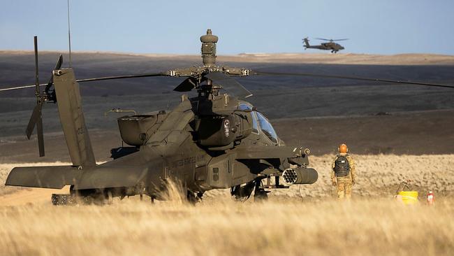 An Australian Army pilot operates a United States Army AH-64E Apache while on exchange with the 16th Combat Aviation Brigade in Washington in March. The Australian Defence Force is a acquiring a fleet of 29 of the attack helicopters to be based in Townsville from 2025. The Australian Government is investing nearly $700 million in Townsville as part of the strategic deployment. Picture: SSG Cayce Watson