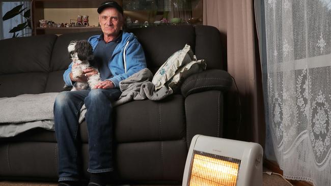 Disability pensioner Ted Evans with dog Fred at home. Ted is concerned with the cost in power increasing with many months of winter to go. Picture: Nikki Davis-Jones
