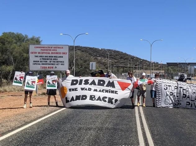 Protesters descend on doors of Pine Gap, demand facility shuts