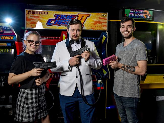 Gamer Georgia Mitchell with Checkpoint esports events organiser and cupid Nathan Farmer and Jack Skinner. Photo: Jerad Williams