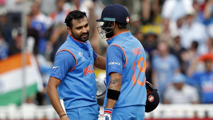 India's Rohit Sharma (L) talks with his batting partner India's captain Virat Kohli (R) after Sharma reached his century  during the ICC Champions Trophy semi-final cricket match between India and Bangladesh at Edgbaston in Birmingham on June 15, 2017. / AFP PHOTO / Adrian DENNIS / RESTRICTED TO EDITORIAL USE
