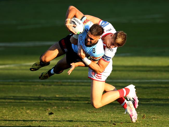 Dragons centre Zac Lomax throws Will Kennedy of the Sharks into the turf. Picture: Jason McCawley/Getty Images