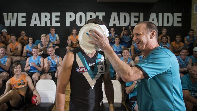 One suspects Ken Hinkley was enjoying humbling Port Adelaide skipper Travis Boak with pie on his face. Picture: Matt Turner.