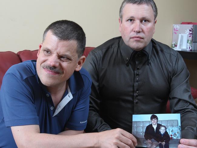 l to r- Adam James and his brother Mark James with a picture of their murdered mother Maria James. Picture: Scott Chris