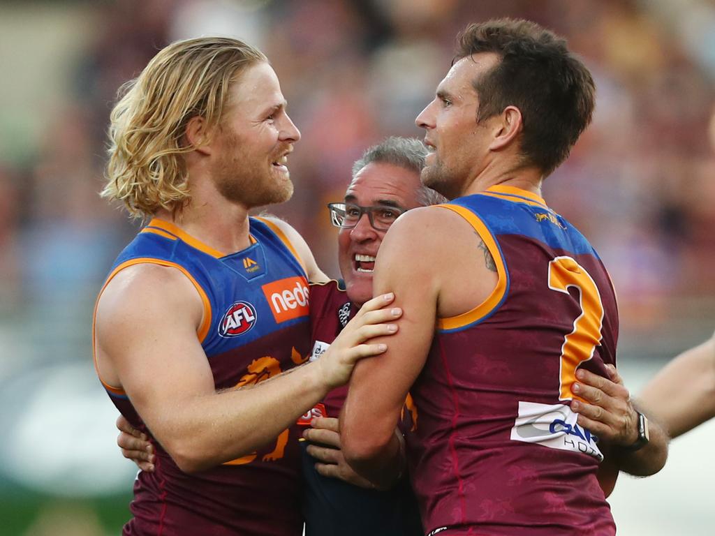 BRISBANE, AUSTRALIA - AUGUST 17: Lions coach Chris Fagan celebrates with players after winning the round 22 AFL match between the Brisbane Lions and the Geelong Cats at The Gabba on August 17, 2019 in Brisbane, Australia. (Photo by Chris Hyde/Getty Images)