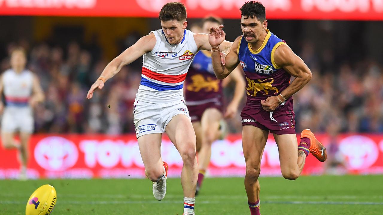 Taylor Duryea famously outhawks Lions speedster Charlie Cameron in Saturday night’s semi final. Picture: AFL Photos/Getty Images