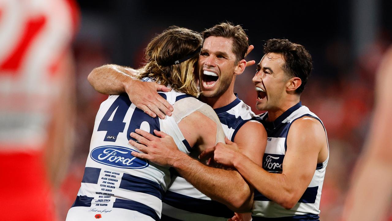 GEELONG, AUSTRALIA - APRIL 22: Tom Hawkins of the Cats celebrates a goal with teammates Mark Blicavs and Sam Simpson during the 2023 AFL Round 06 match between the Geelong Cats and the Sydney Swans at GMHBA Stadium on April 22, 2023 in Geelong, Australia. (Photo by Dylan Burns/AFL Photos via Getty Images)