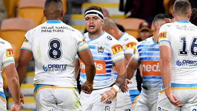 Ashley Taylor of the Titans (centre) celebrates a try during the Round 7 NRL match between the Brisbane Broncos and the Gold Coast Titans at Suncorp Stadium in Brisbane, Saturday, June 27, 2020. (AAP Image/Dan Peled) NO ARCHIVING, EDITORIAL USE ONLY