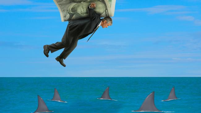 Man with wings made of money flying over school of sharks representing financial success, stock market advice, survival, retirement savings, planning, business strategies, finance & higher education. Istock