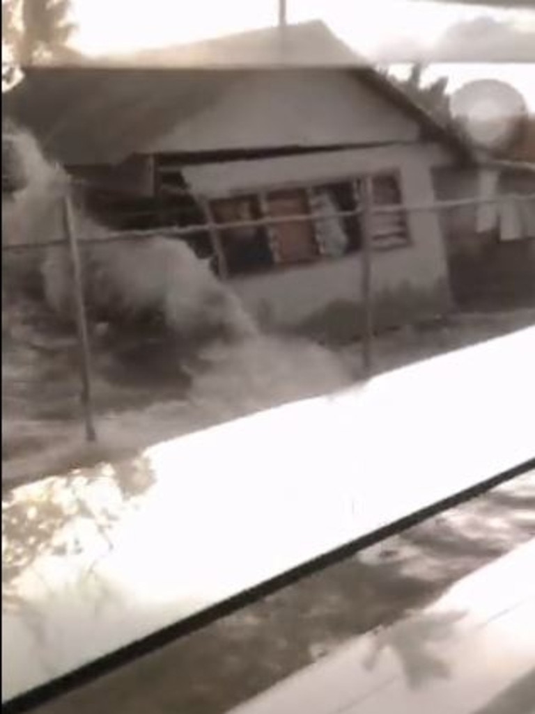Screen grabs from footage of a church in Tonga when the tsunami hit. Twitter/Johnnyteiser