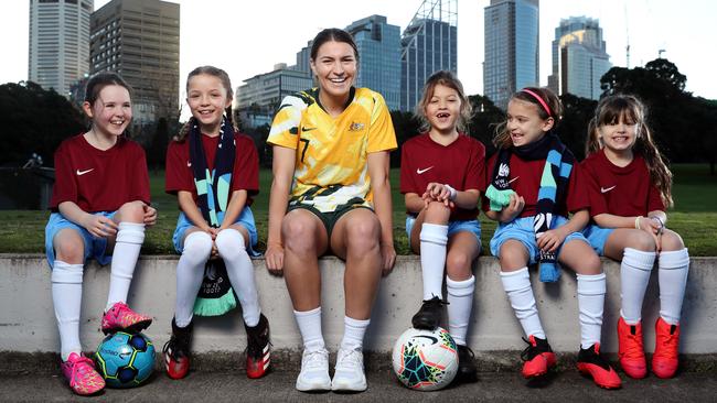 Matildas player Steph Catley with Leichhardt Tigers players, Seren Taylor, 8, Sienna Stokoe Fitzpatrick, 9, Isabella Mark, 8, Emilia Bivona, 8, and Allegra Bivona, 6, in Sydney on Friday. Picture: Jonathan Ng