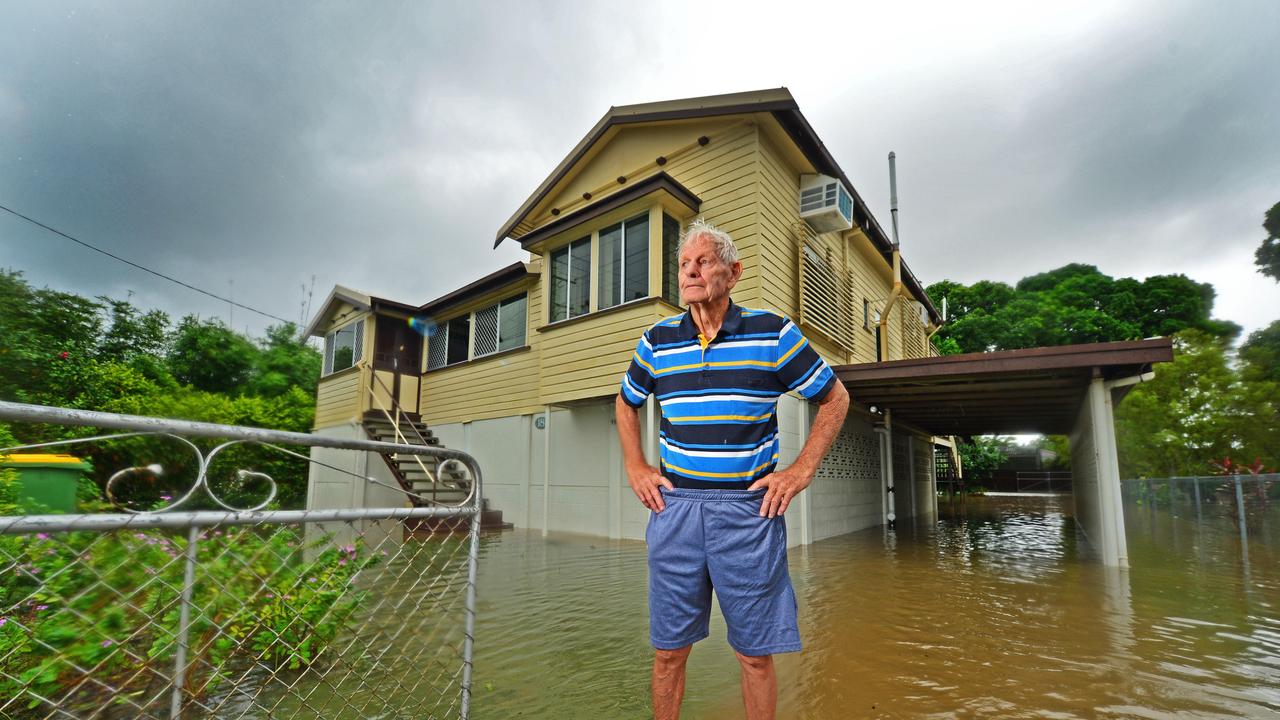 Bob Fielding, 80, stands out the front of his flooded Queens Road home in Railway Estate. Picture: Zak Simmonds