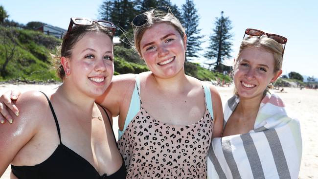 Schoolies Caira Morbato, Maggie Boland and Lilly Federighi from Morninton Peninsular relax at Clarkes Beach in Byron Bay. Photograph: Jason O'Brien