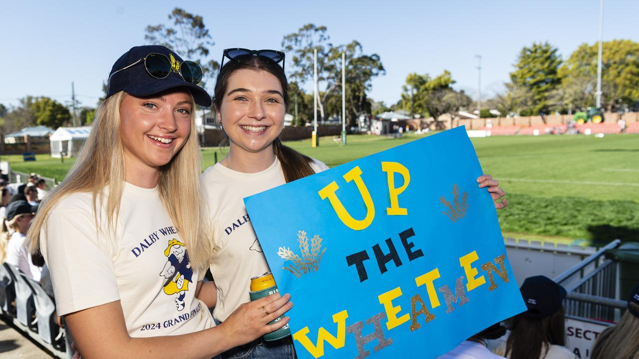 Chloe Capes (left) and Clare Adcock get behind the Wheatmen Downs Rugby grand final day at Clive Berghofer Stadium, Saturday, August 24, 2024. Picture: Kevin Farmer