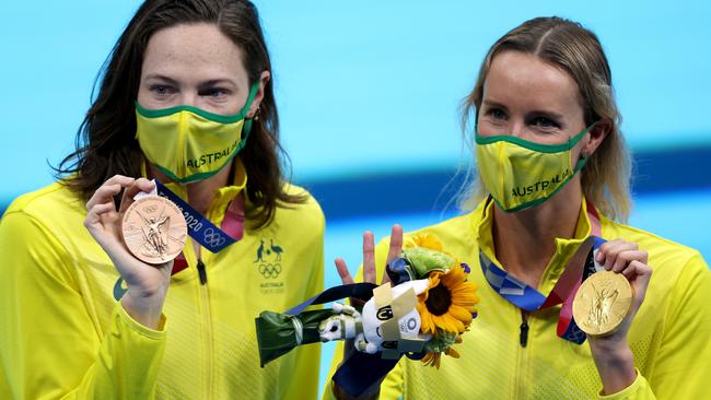 Emma McKeon and Cate Campbell show off their medals.