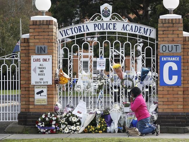 Mourners lay flowers at the police academy after four officers were killed on the Eastern Freeway in April.