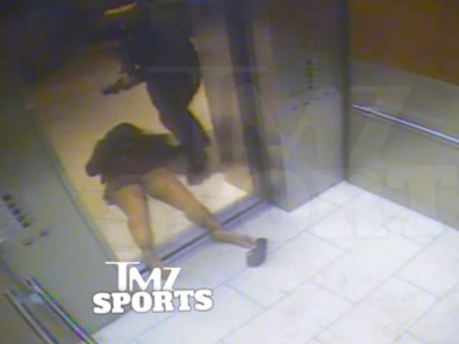 In this still image released by TMZ Sports, Ray Rice drags his fiancee, Janay Palmer, out of an elevator moments after knocking her out.