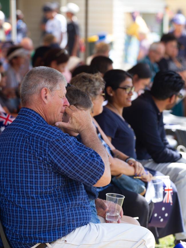 Guests sat under the cool shade of the tents during the hot summer day.